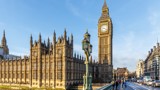 Photo of the Houses of Parliament and Big Ben, taken from Westminster bridge, with a bright blue sky.