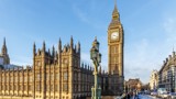 Photo of the Houses of Parliament and Big Ben, taken from Westminster bridge, with a bright blue sky.