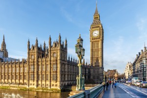 Photo of the Houses of Parliament and Big Ben, taken from Westminster bridge, with a bright blue sky.