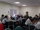 Photo of participants sitting at round tables engaged in activity