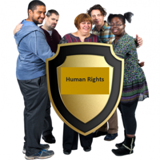 Photo of group of people gathered around a shield that says "Human Rights"